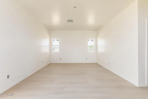 an empty room with windows and closet
