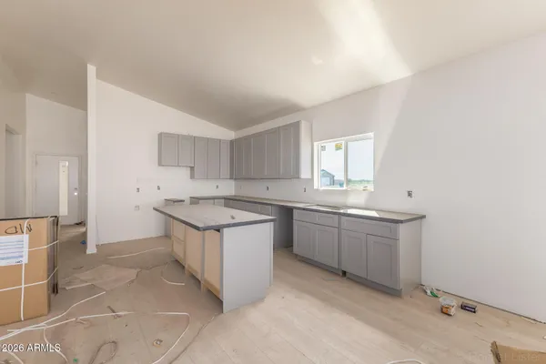 a kitchen with granite countertop a sink stove and cabinets