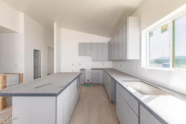 a kitchen with a stove a sink and a refrigerator