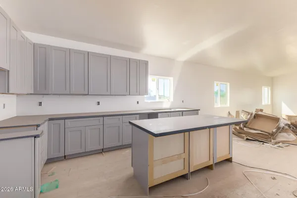 a kitchen with a sink stove and cabinets