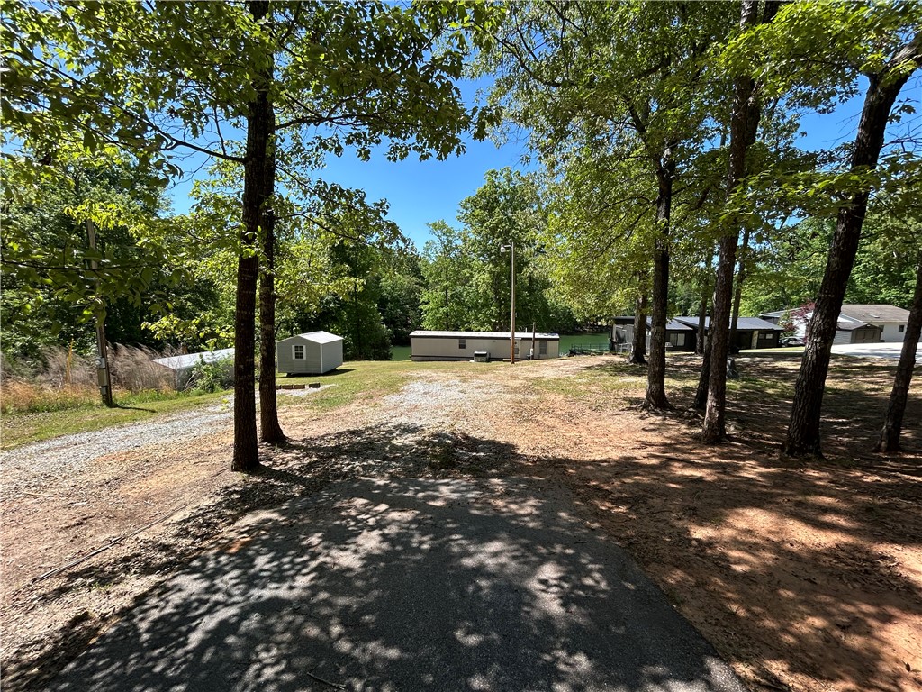 43 Sunset Cove Road Abbeville, SC 29620 - Photo 37 of 41 This scenic lot offers a tranquil escape with lush greenery and direct water access.