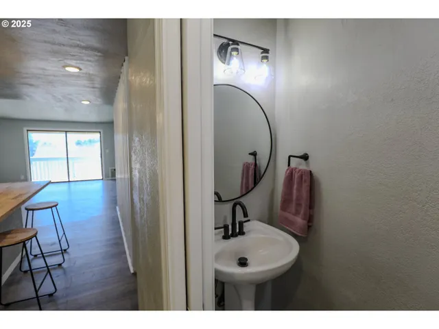 a bathroom with a toilet mirror and vanity