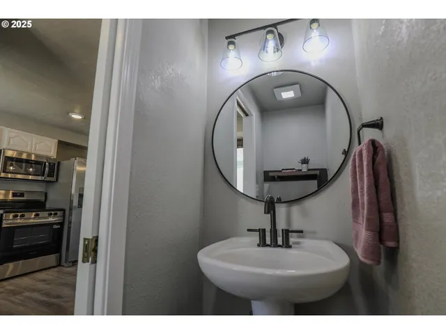 a picture of a bathroom with a sink and a mirror