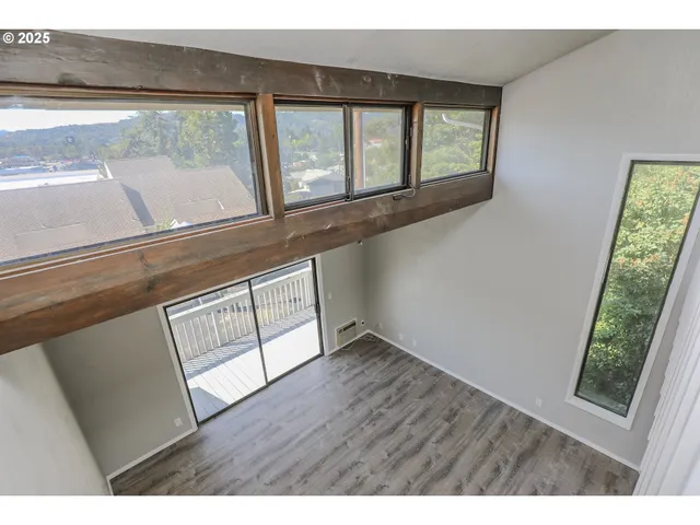 a view of an entryway with wooden floor