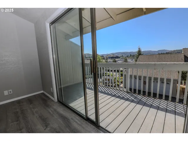 a view of balcony with wooden floor