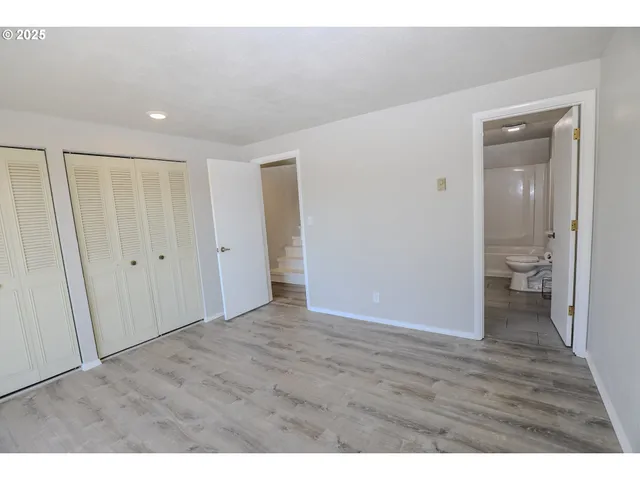 a view of a room with wooden floor
