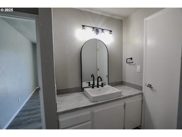 a bathroom with a double vanity sink and a mirror