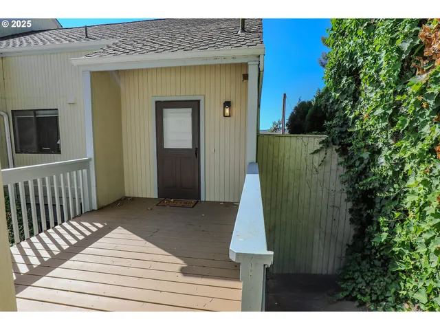 a view of a house with a wooden deck