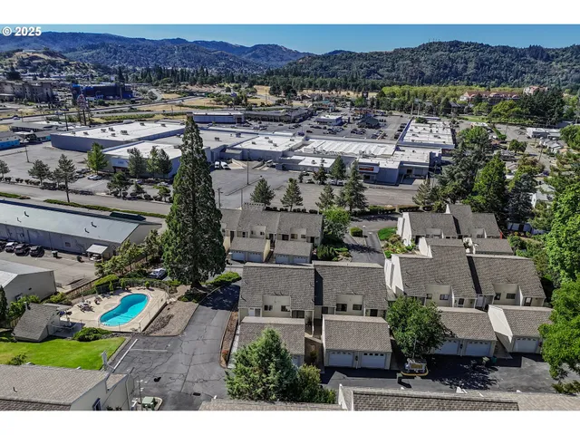 an aerial view of residential house and sandy dunes