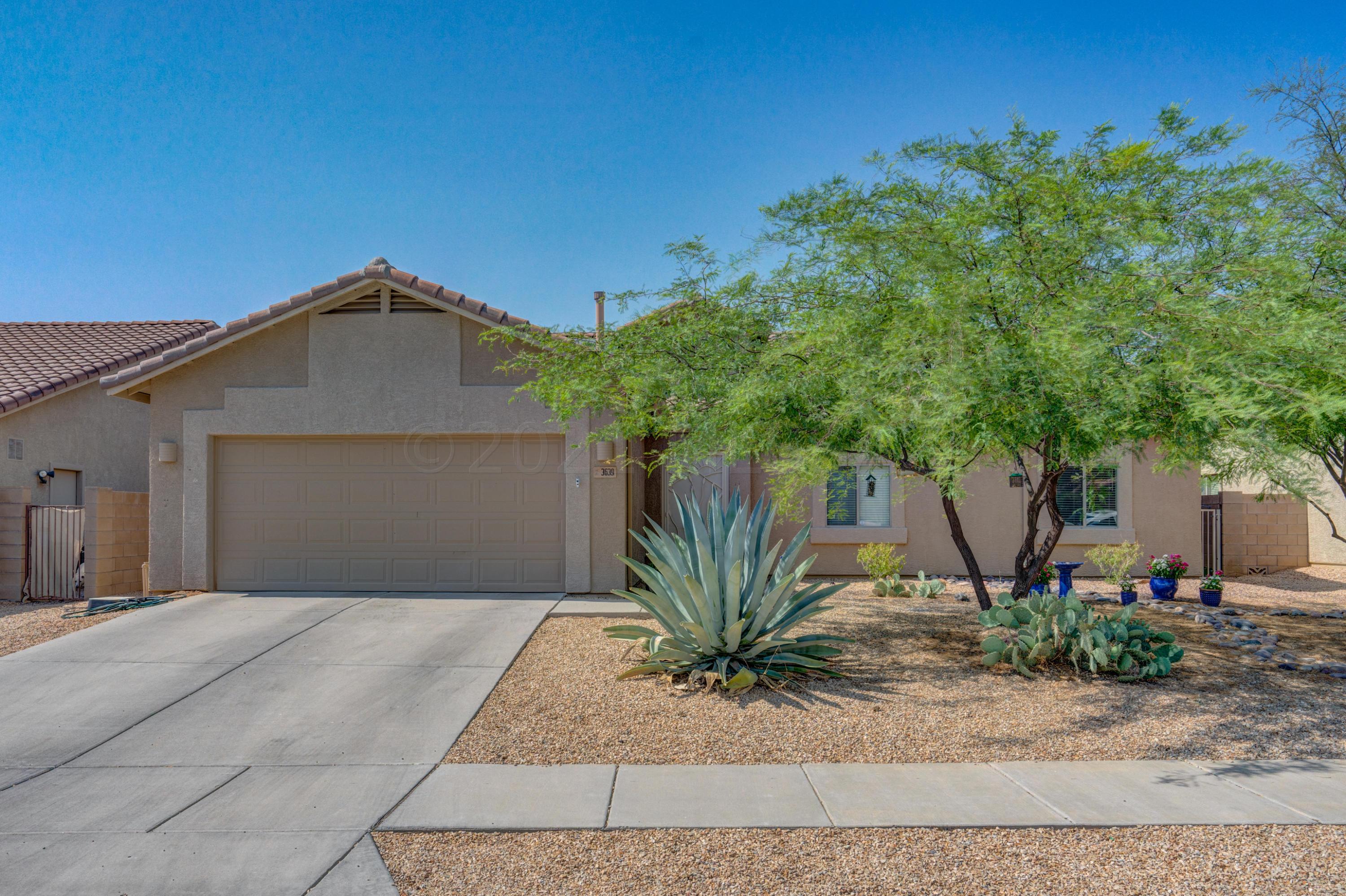 3639 East Northern Dancer Road Tucson, AZ 85739 - Photo 1 of 48 a front view of a house with a yard