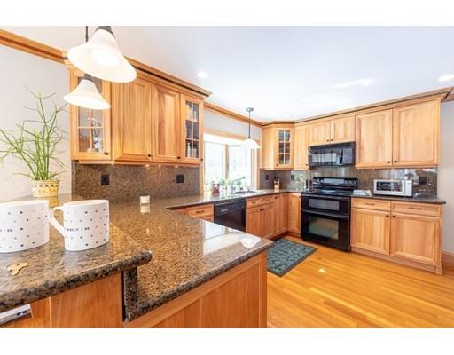 56 Gleason Road Reading, MA 01867 - Photo 11 of 32 a kitchen with stainless steel appliances granite countertop a sink a stove and a microwave