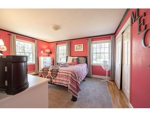 56 Gleason Road Reading, MA 01867 - Photo 13 of 32 a spacious bedroom with a bed and wooden floor