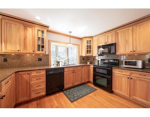 56 Gleason Road Reading, MA 01867 - Photo 15 of 32 a kitchen with stainless steel appliances granite countertop a stove top oven a sink dishwasher and a microwave oven with cabinets