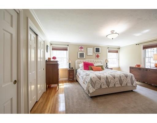 56 Gleason Road Reading, MA 01867 - Photo 16 of 32 a bedroom with a large bed and wooden floor