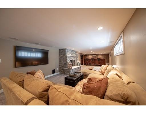 56 Gleason Road Reading, MA 01867 - Photo 31 of 32 a living room with furniture and a flat screen tv