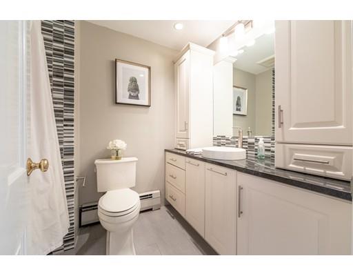56 Gleason Road Reading, MA 01867 - Photo 6 of 32 a bathroom with a toilet a sink and mirror