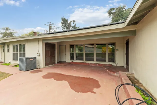 a view of a house with a backyard and windows