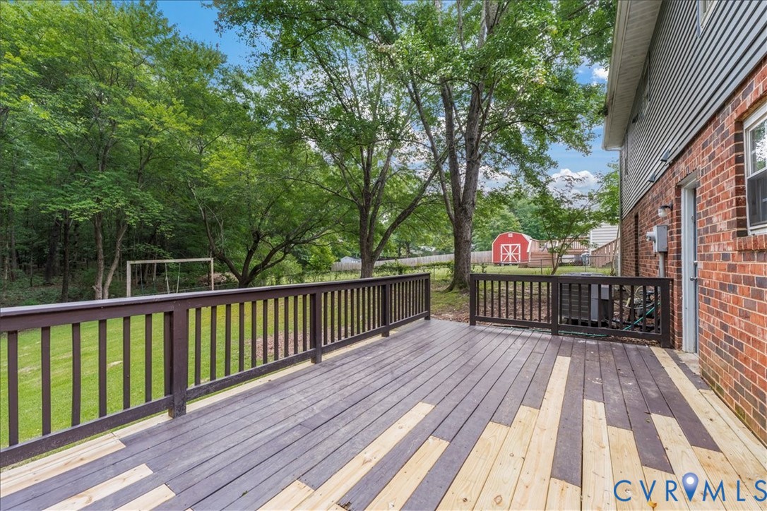 6208 Barrister Road Chesterfield, VA 23832 - Photo 31 of 37 Expansive wooden deck with dark railing, offering