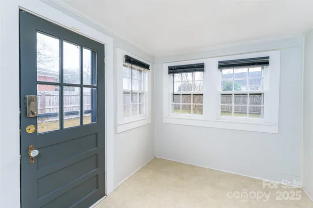 a view of entryway and hall with a living room