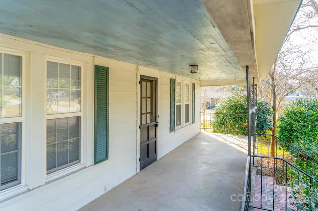a view of a house with a yard patio and fire pit