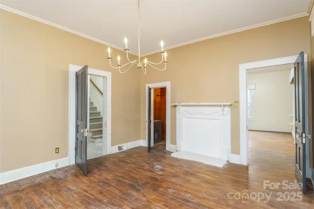 an empty room with closet and a chandelier fan