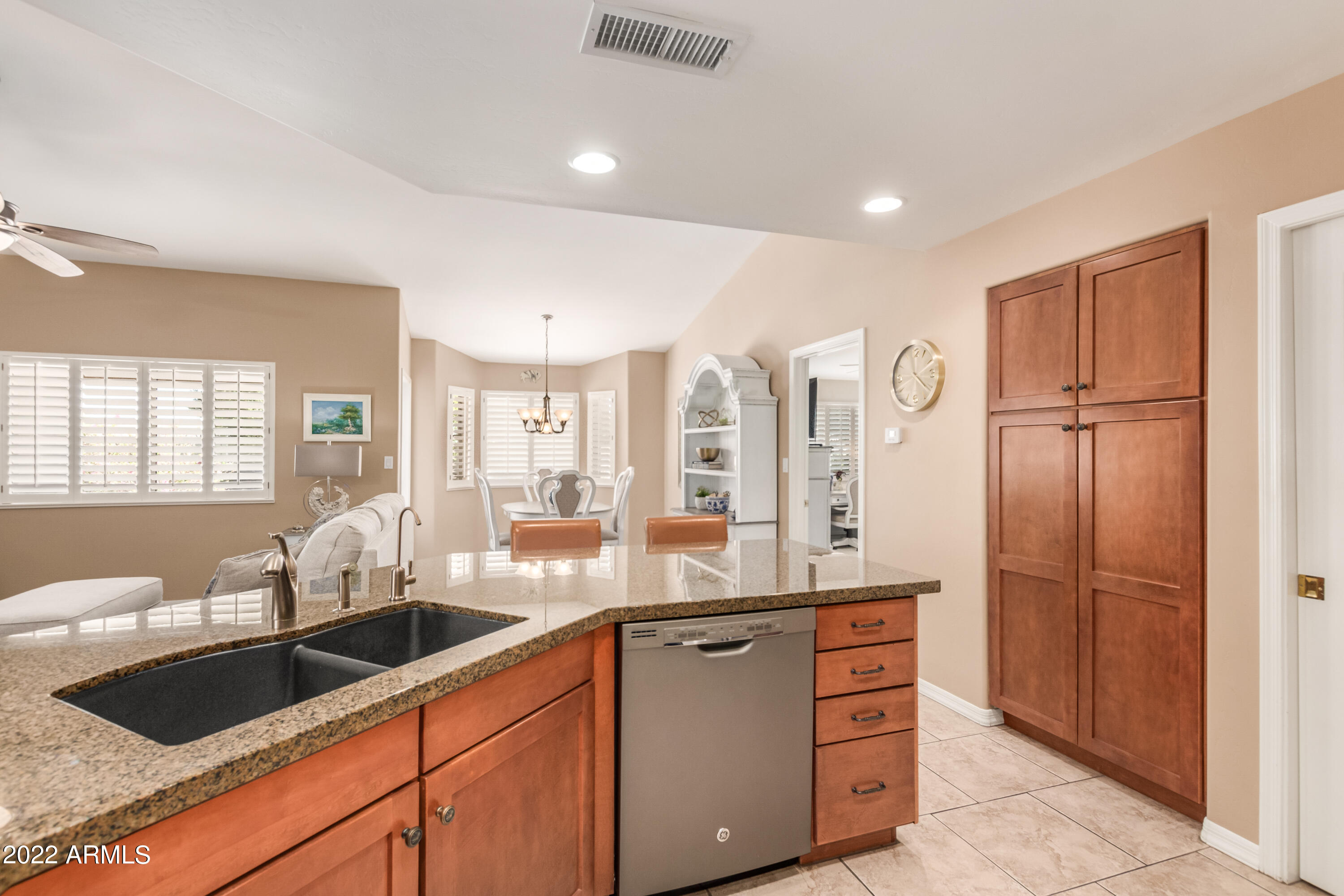 5830 East McKellips Road, Unit 76 Mesa, AZ 85215 - Photo 10 of 33 a kitchen with stainless steel appliances granite countertop a sink and cabinets