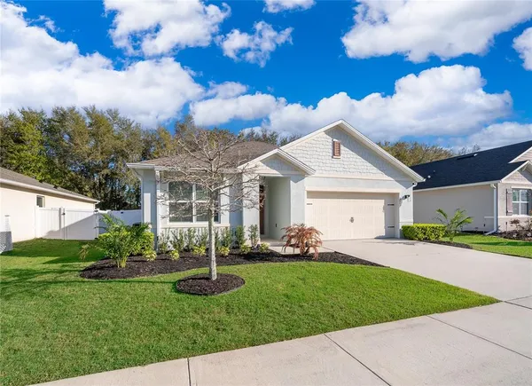 a front view of a house with garden and patio