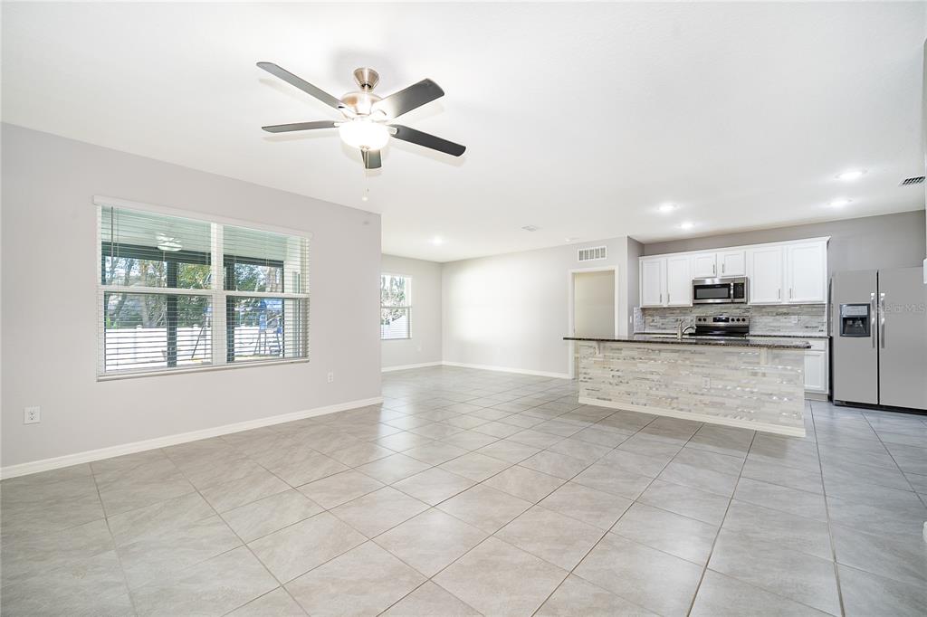 3102 Bethpage Loop Mount Dora, FL 32757 - Photo 13 of 29 a view of kitchen with refrigerator and window