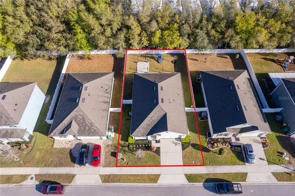 an aerial view of residential houses with outdoor space