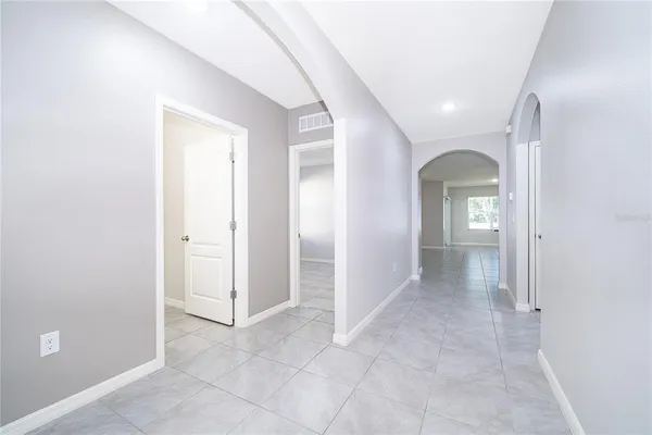 an entryway with a white walls and cabinet