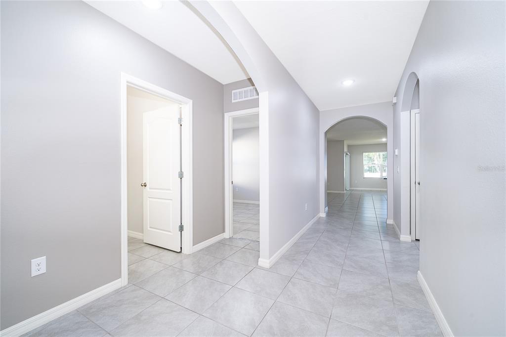 3102 Bethpage Loop Mount Dora, FL 32757 - Photo 8 of 29 an entryway with a white walls and cabinet