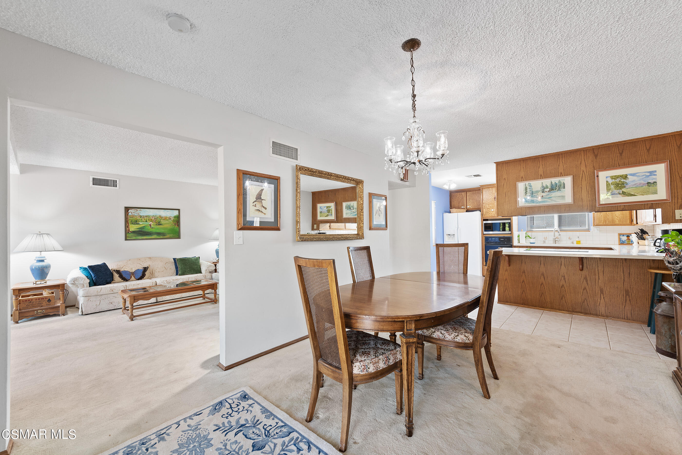 3291 Travis Avenue Simi Valley, CA 93063 - Photo 15 of 54 a dining room with furniture a chandelier and wooden floor