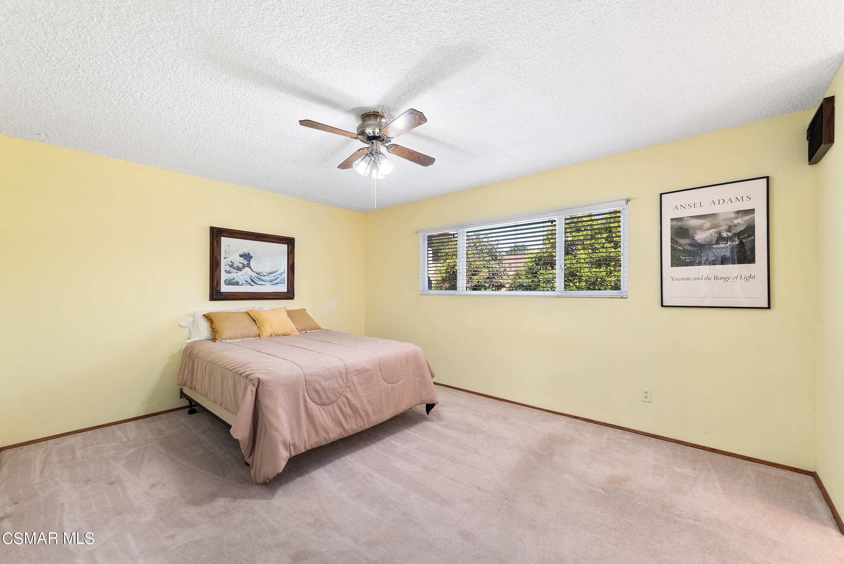 3291 Travis Avenue Simi Valley, CA 93063 - Photo 17 of 54 a spacious bedroom with a bed painting on the wall and a window
