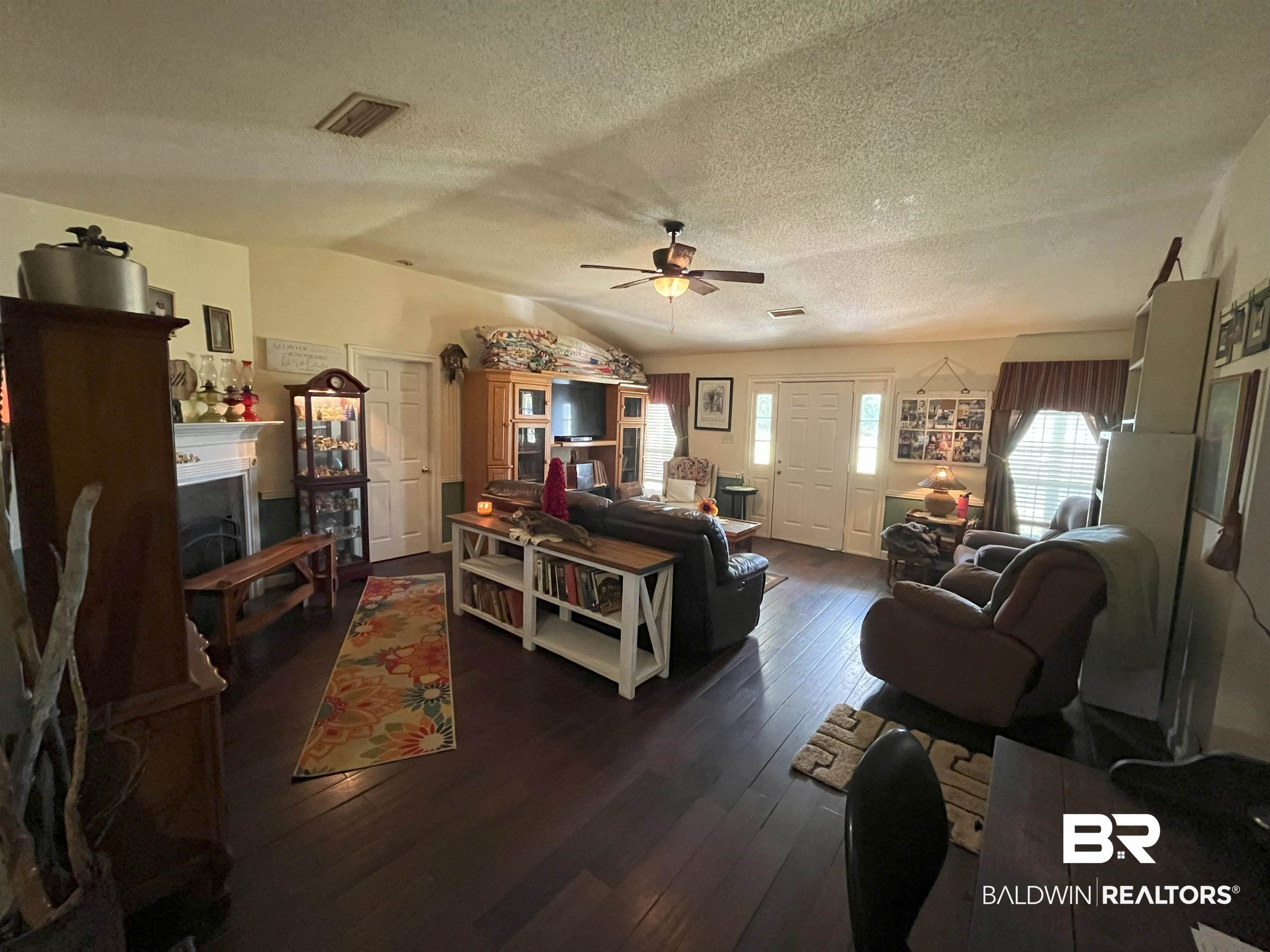 7851 Highway 98 Fairhope, AL 36532 - Photo 7 of 40 Living area with lofted ceiling, dark wood-style flooring, a textured ceiling, and ceiling fan