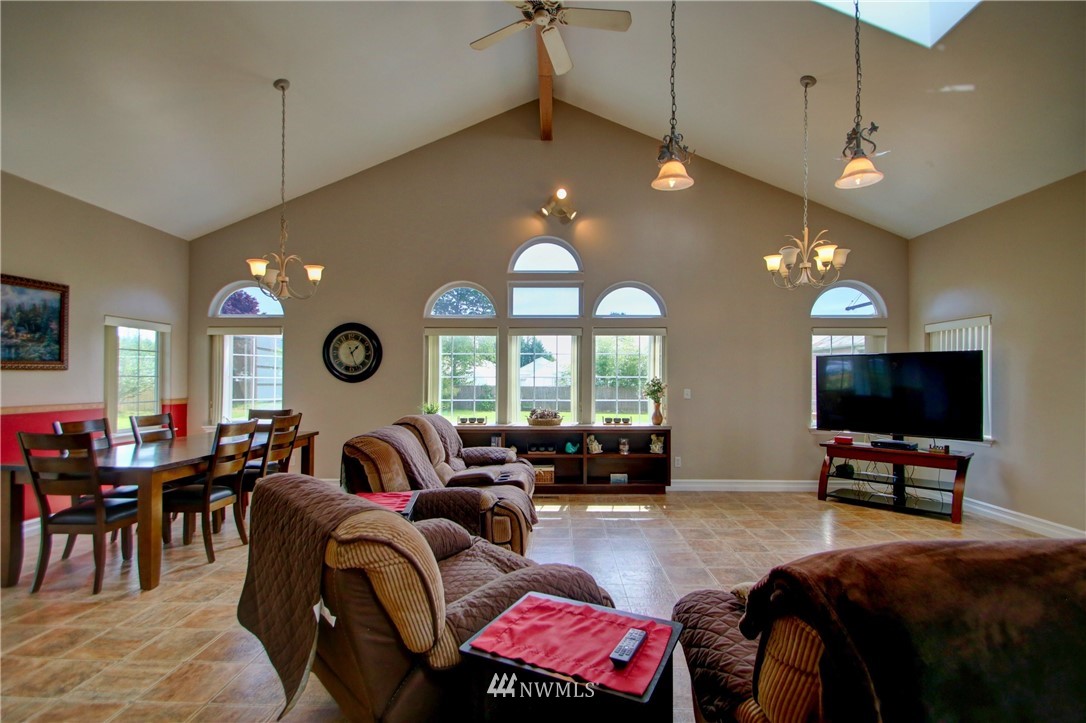 17566 Dunbar Road Mount Vernon, WA 98273 - Photo 11 of 40 a living room with furniture a large window and a flat screen tv
