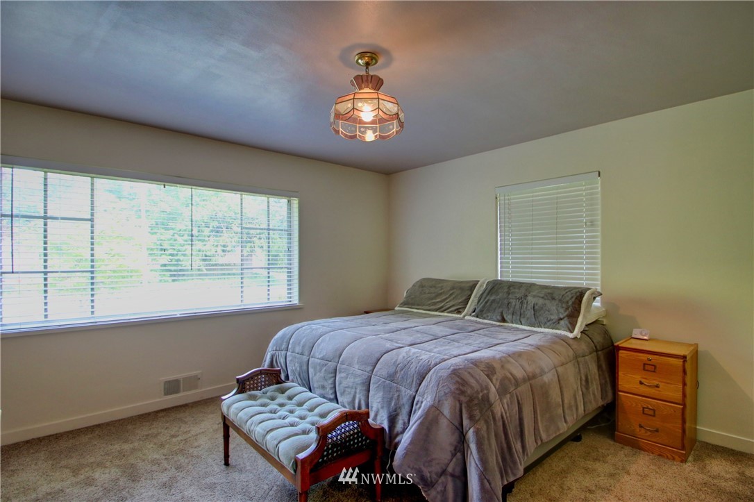17566 Dunbar Road Mount Vernon, WA 98273 - Photo 14 of 40 a bedroom with a bed and a window