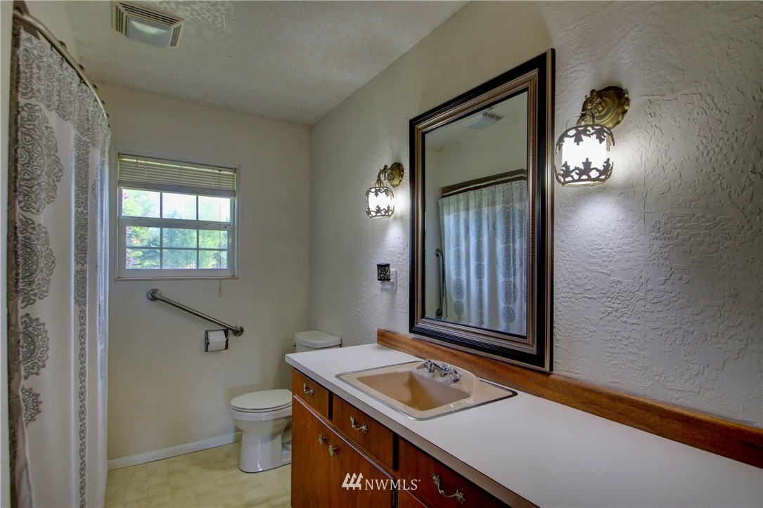 17566 Dunbar Road Mount Vernon, WA 98273 - Photo 15 of 40 a bathroom with a sink a toilet and mirror