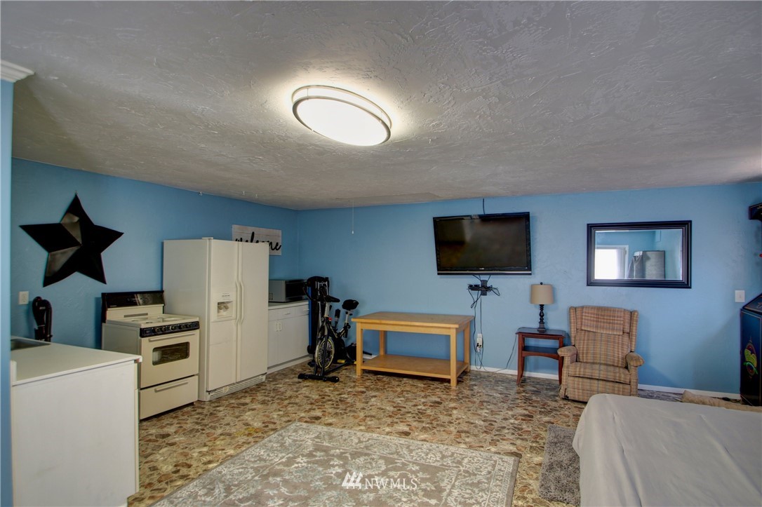 17566 Dunbar Road Mount Vernon, WA 98273 - Photo 26 of 40 a living room with furniture and a flat screen tv