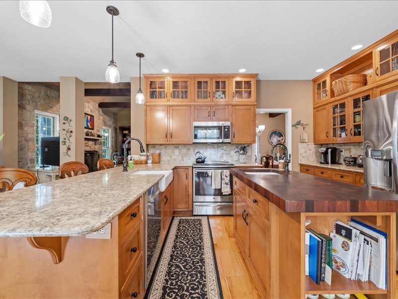 1168 Mt Pleasant Road Bangor, PA 18013 - Photo 34 of 100 Warm wood cabinetry and expansive dual islands anchor this open kitchen design.