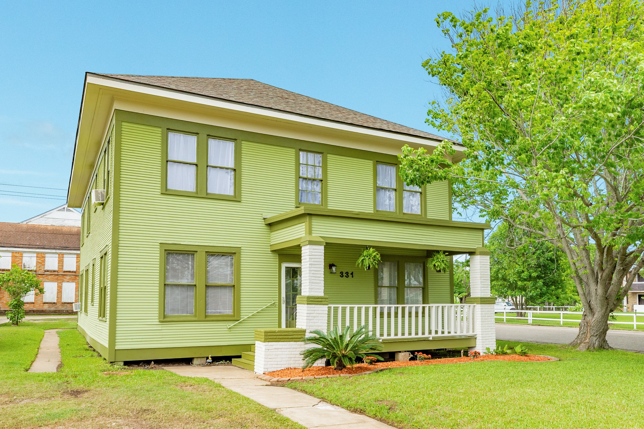 a front view of a house with a garden