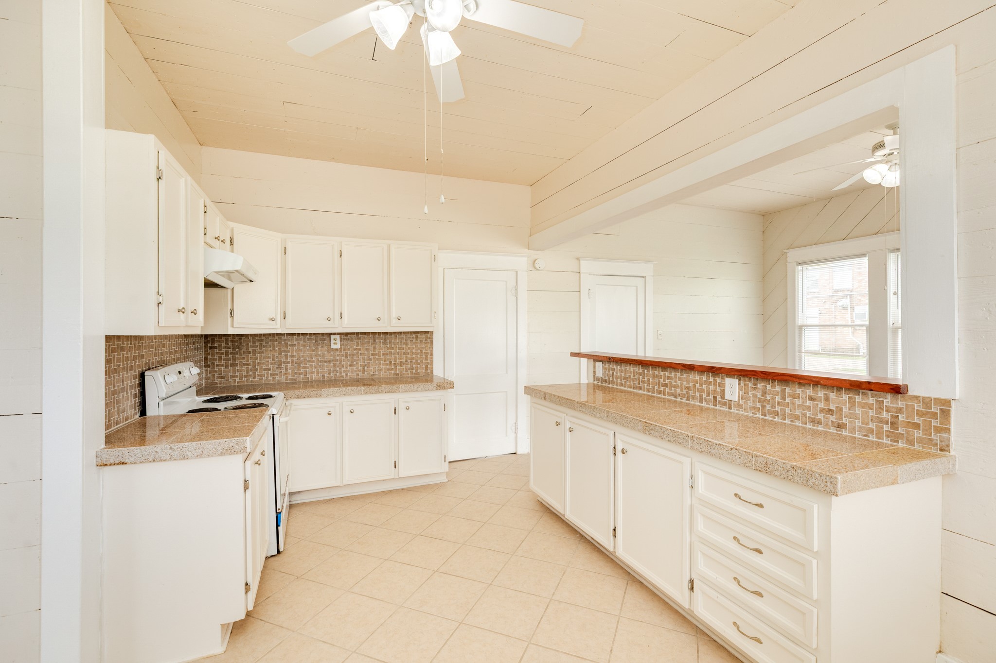 331 West Broad Street Freeport, TX 77541 - Photo 12 of 31 a kitchen with granite countertop white cabinets and white appliances