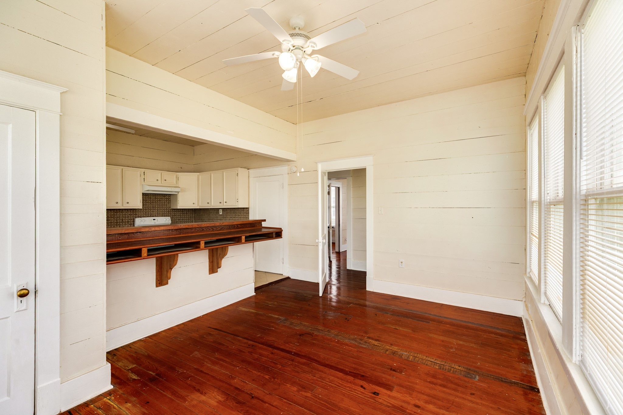 331 West Broad Street Freeport, TX 77541 - Photo 14 of 31 a view of a room with wooden floor and a ceiling fan