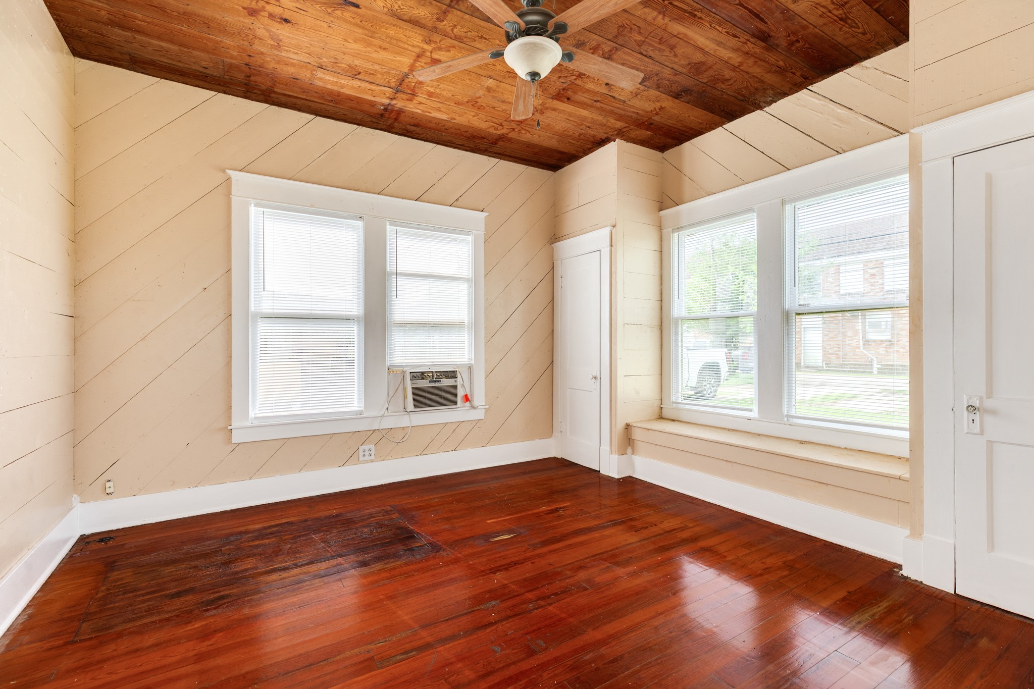 331 West Broad Street Freeport, TX 77541 - Photo 16 of 31 an empty room with wooden floor and windows