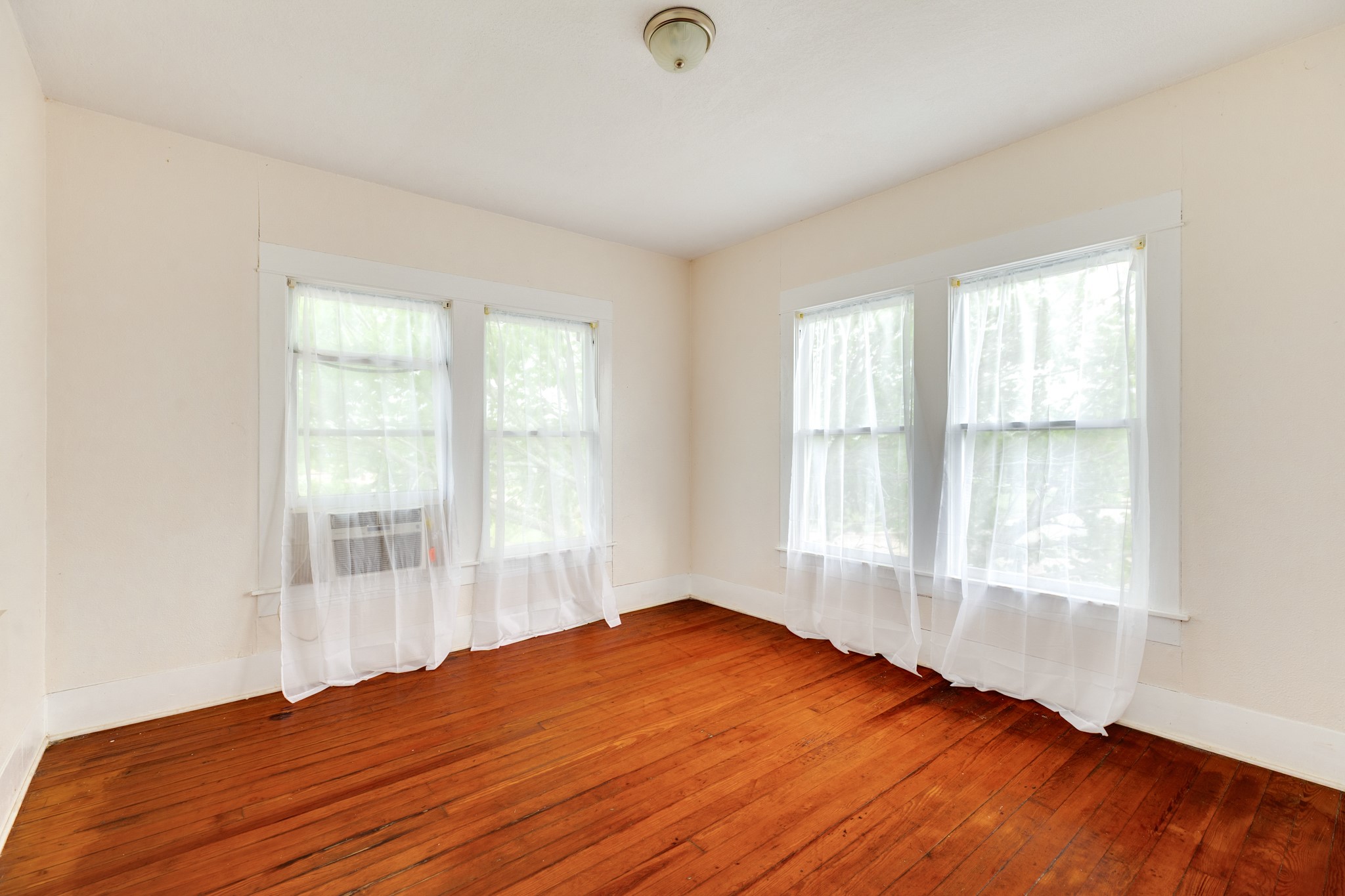 331 West Broad Street Freeport, TX 77541 - Photo 23 of 31 a view of an empty room with wooden floor and a window