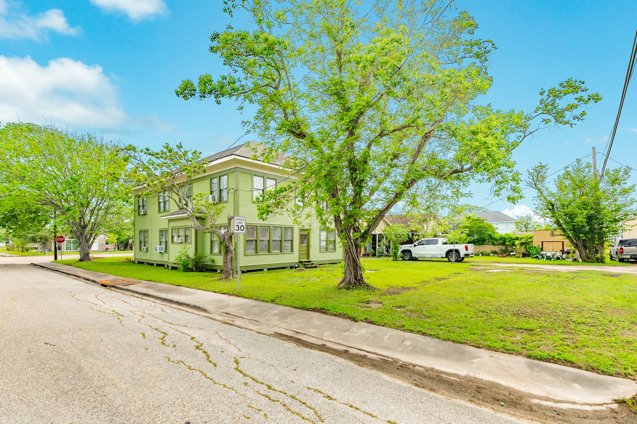 331 West Broad Street Freeport, TX 77541 - Photo 31 of 31 a view of a house with a big yard and potted plants and large trees