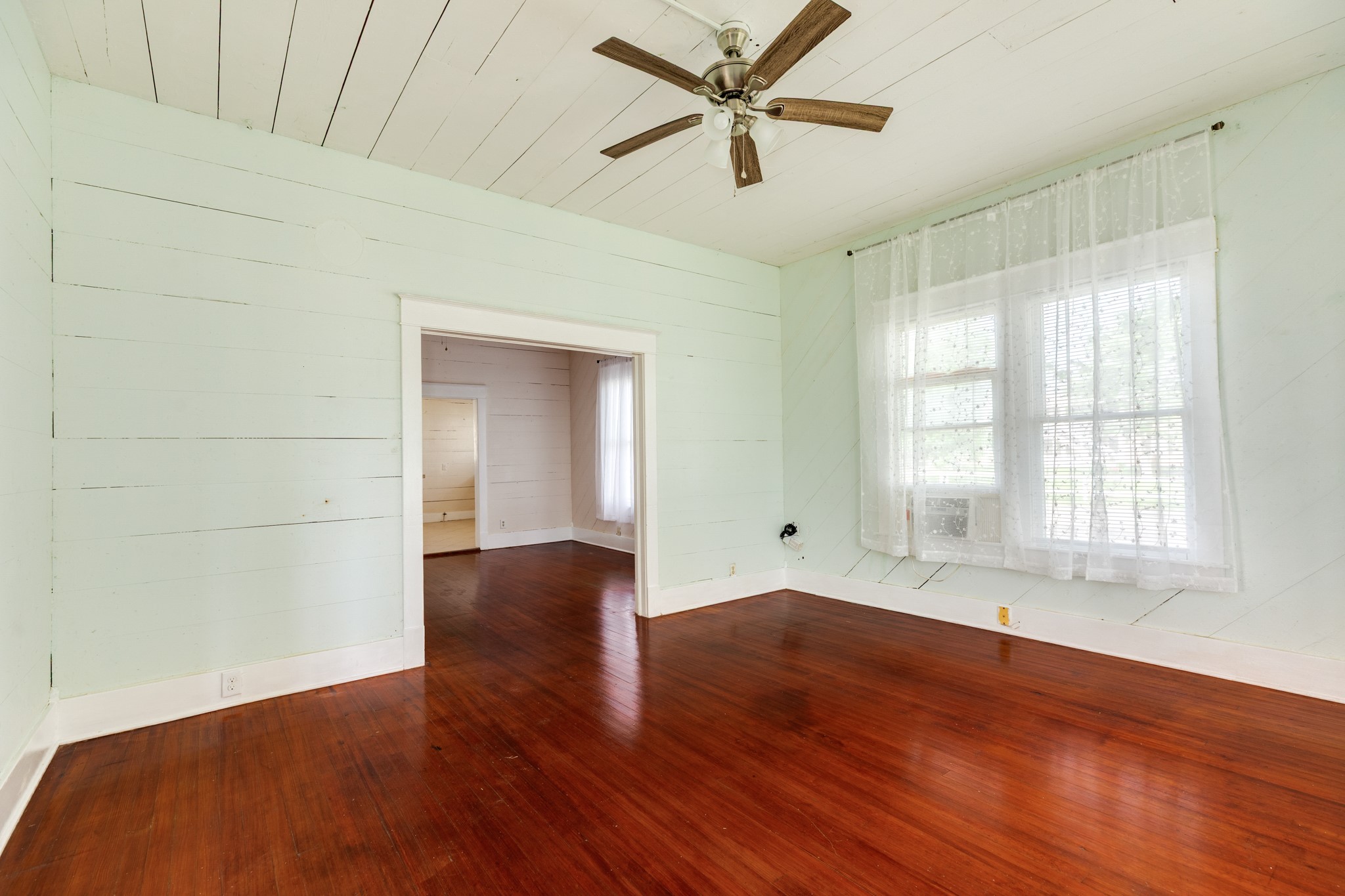 331 West Broad Street Freeport, TX 77541 - Photo 6 of 31 wooden floor in an empty room with a window