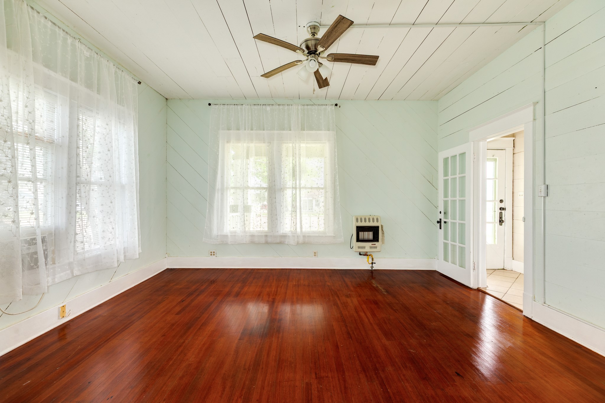 331 West Broad Street Freeport, TX 77541 - Photo 7 of 31 a view of empty room with wooden floor and fan