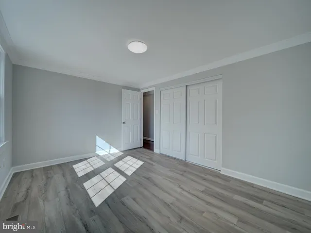 a view of wooden floor and windows in a room