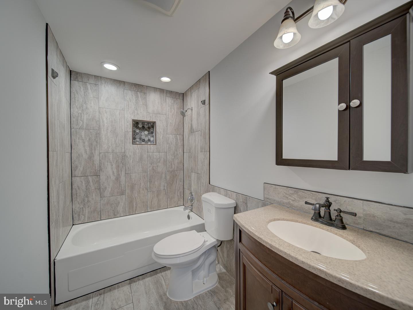 1300 East Beech Road Sterling, VA 20164 - Photo 17 of 35 a bathroom with a granite countertop sink toilet and shower