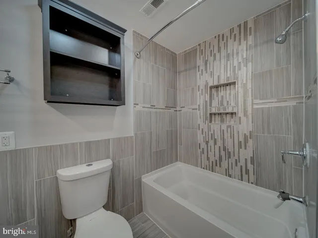 a bathroom with a toilet a sink and bathtub